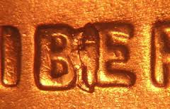 Close-up of 2019 Lincoln penny showing the BIE die crack error — a raised line between B and E in LIBERTY resembling an extra letter I